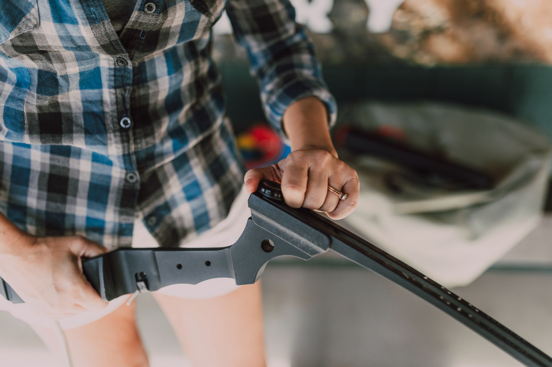 A sword blade resting on an anvil beside a video game controller in a blacksmith's forge.